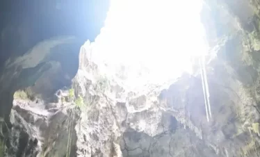 An opening at the top of the cave, letting the sunlight causing the cave to look differently from according to where you stand