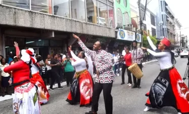 traditional dancers perform at a street celebration.