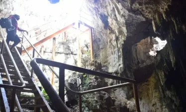 A cave descending 100 feet underground with a crystal-clear saltwater pool at Gaspar Grande, Trinidad.