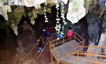 A cave descending 100 feet underground with a crystal-clear saltwater pool at Gaspar Grande, Trinidad.