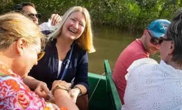 visitors enjoying some local cuisine while in the beautiful nature of the caroni swamp