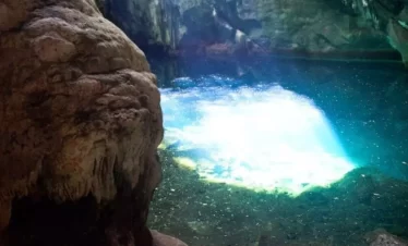 A clear pool of 30 feet in diameter at the Blue Grotto which reflects the sunlight that streams through a hole at the top of the cave.