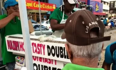 A street food vendor preparing doubles at a street food spot in Trinidad