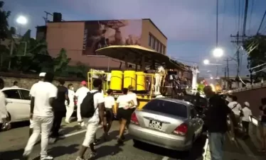 pan layers on the streets at night celebrating "pan and powder" a celebration that signals the start of the panorama season in trinidad. panorama is a major event in trinidad's carnival where over 150 steelbands take part.