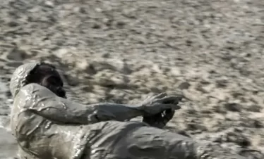 a man sliding down a volcanic mud slope
