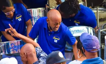 pan players playing in their panyard for an appreciative crowd