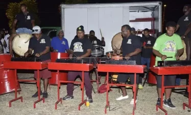 A group of traditional musicans playing percussive instruments
