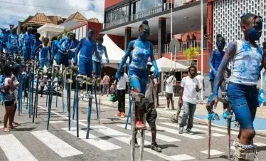 children on wooden stilts practicing for a main performance